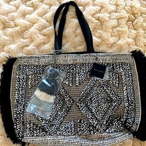 Oversized black and silver America & Beyond tote bag.